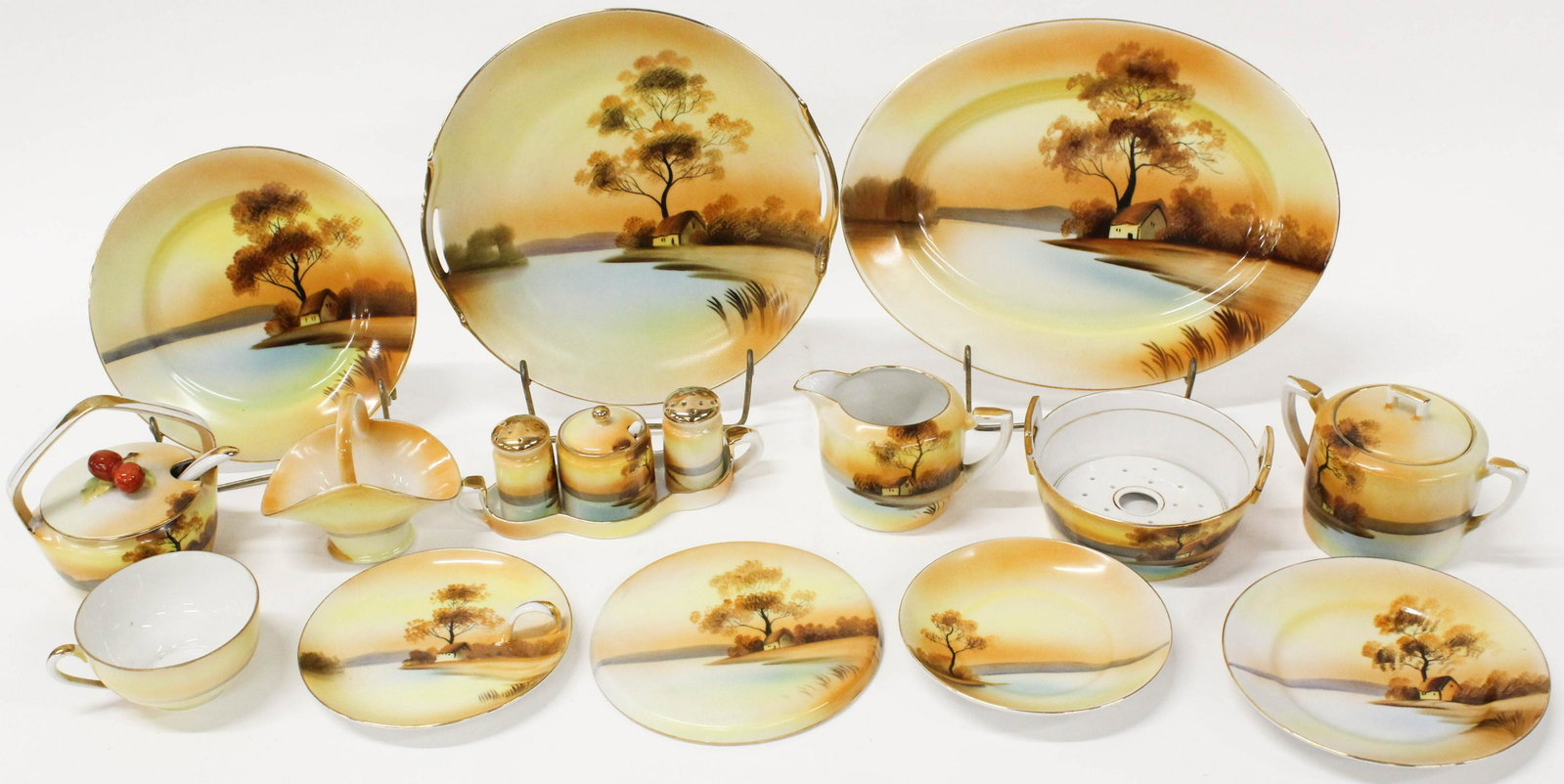 35 pcs. Nippon Morimura Sunset Porcelain Items: 35 pcs. 1920's Nippon Morimura Sunset Porcelain Items including preserve jar, sugar and creamer, butter dish, conidment set, tivets, bon bon dishes, luncheon plates, dessert plates,