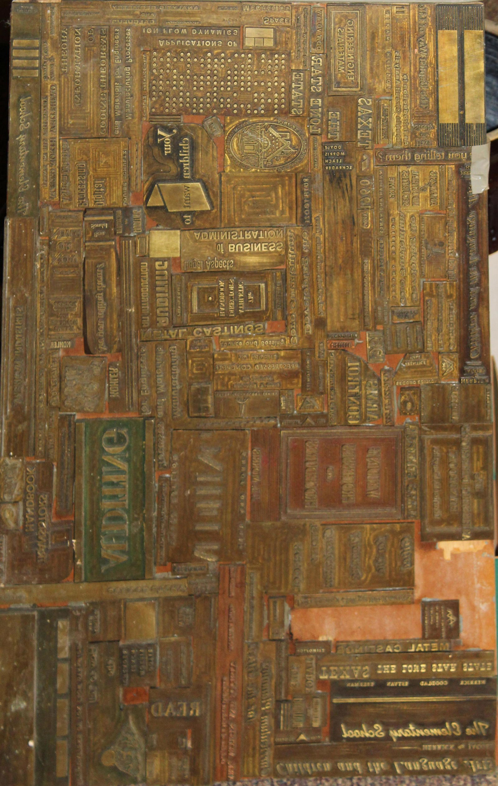 Two printers trays and a collage of plates: Two early 20th c printers trays and an unusual collage of brass printing plates