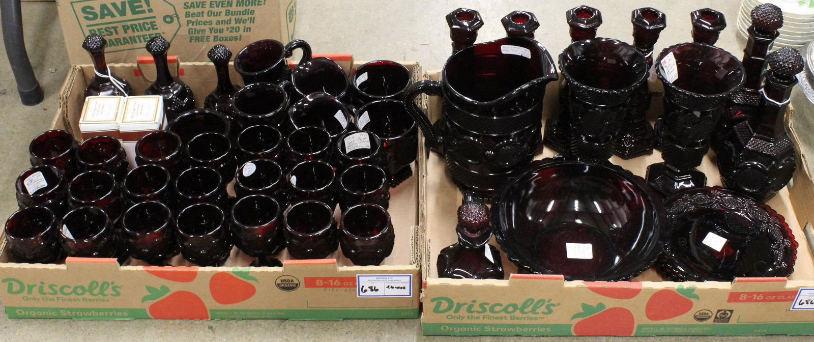 48 pcs. Avon Cape Cod Ruby Red Glassware: 48 pcs. Avon Cape Cod Ruby Red Glassware including bells, wine goblets, sugar and creamers, mugs, pitcher, 2 vases, 2 decanters, 5 candlesticks, bowl, plates, cruet, etc.