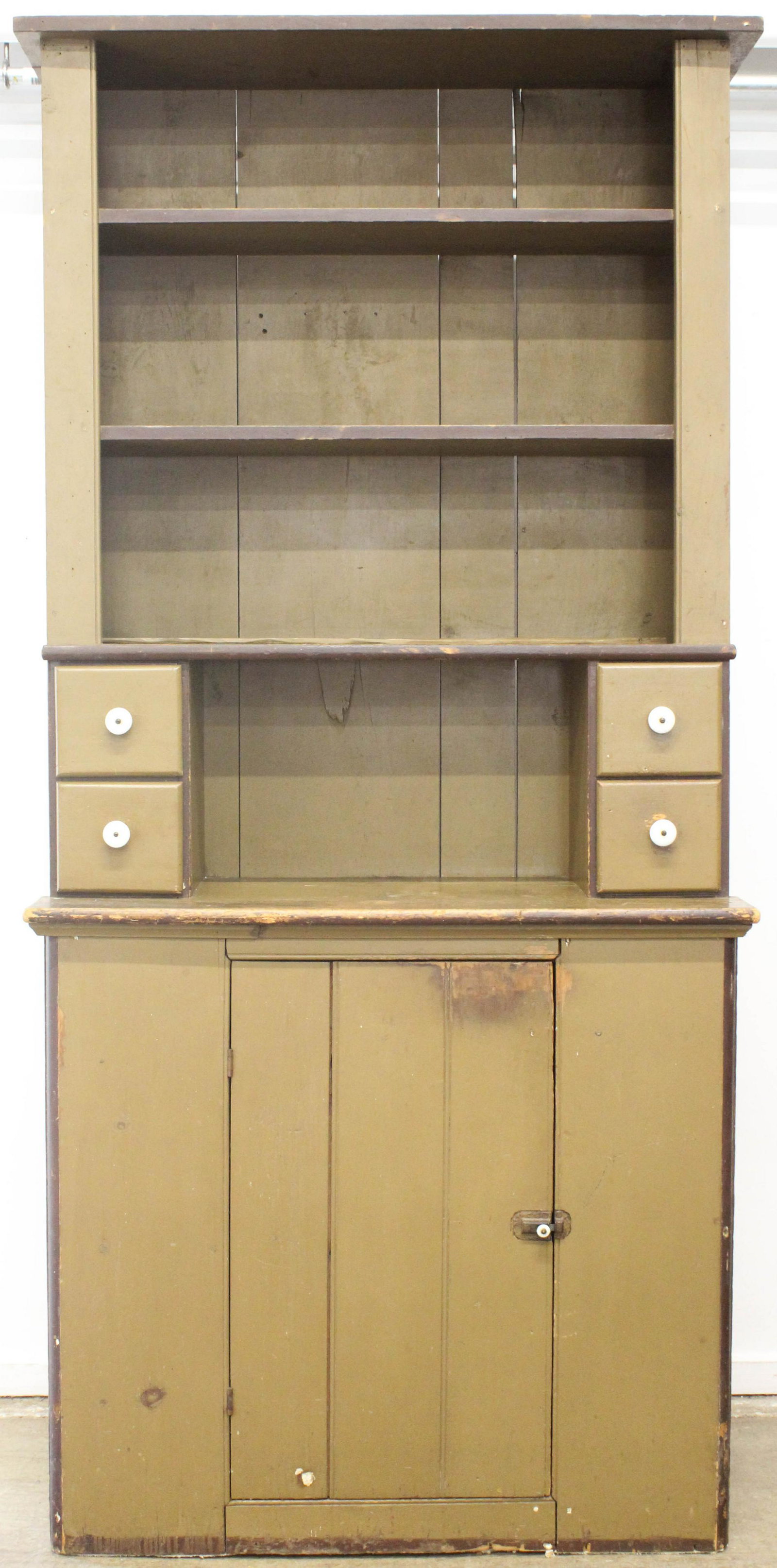 Early 20th c Stepback Kitchen Cupboard: Early 20th c green painted pine kitchen step back cupboard, open shelves over 4 drawers over 1 door, width 37", ht 7'