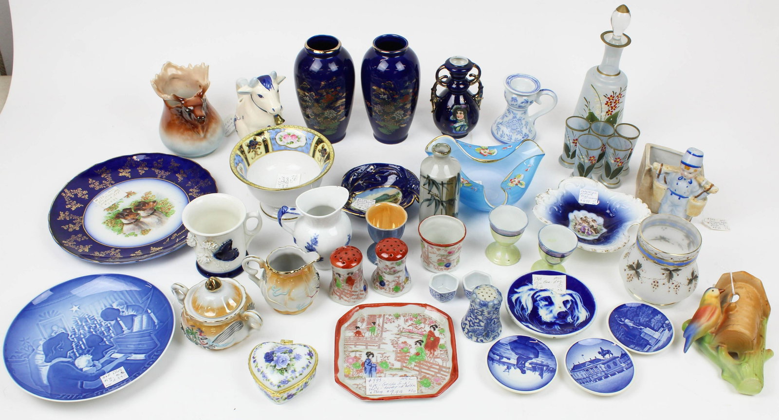 Lot of Mixed Porcelain and Glass Items: Lot of Mixed Porcelain and Glass Items including souvenir china, Austrain moose creamer, Royal Copenhagen creamer, Japanese pottery, Bohemian glass cordial set, etc.