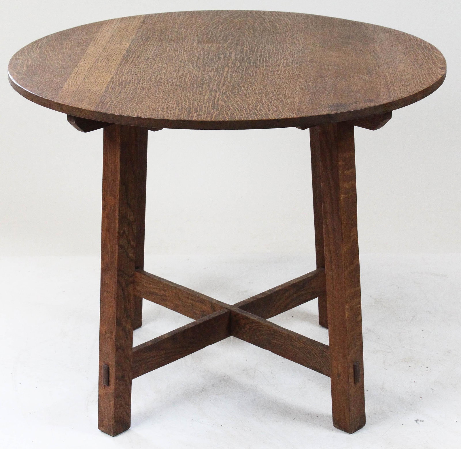 Limberts Oak Parlor Table: Limbert round oak parlor table or lamp table. Arts & Crafts 4 tendon stretcher supported canted legs. Limberts brand mark under top. 36" diameter 29" high.