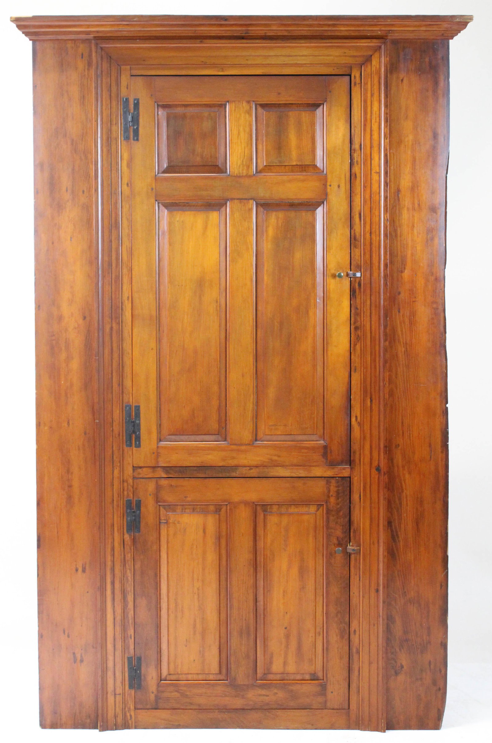 18th New England Pine architectural Cupboard: 18th c New England pine two door cupboard. Cross panel upper door with 4 plate grooved shelves over panel lower door. Picture frame molding then wall board still attached. Original iron L hinges, rose