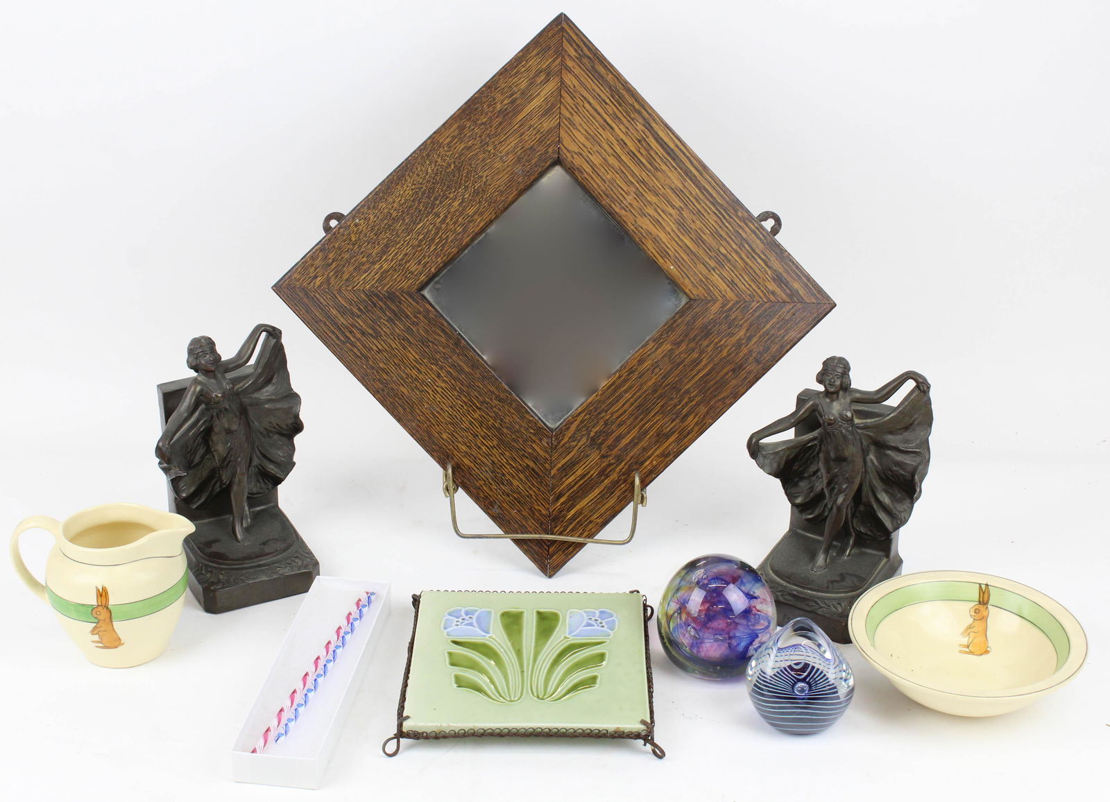 Group of Art Pottery and Accessories: Group of art pottery and accessories including Roseville "Juvenile" rabbit decorated porridge bowl and creamer, Art Nouveau tile trivet, cast metal flapper bookends, quartersawn oak frame mirror, two