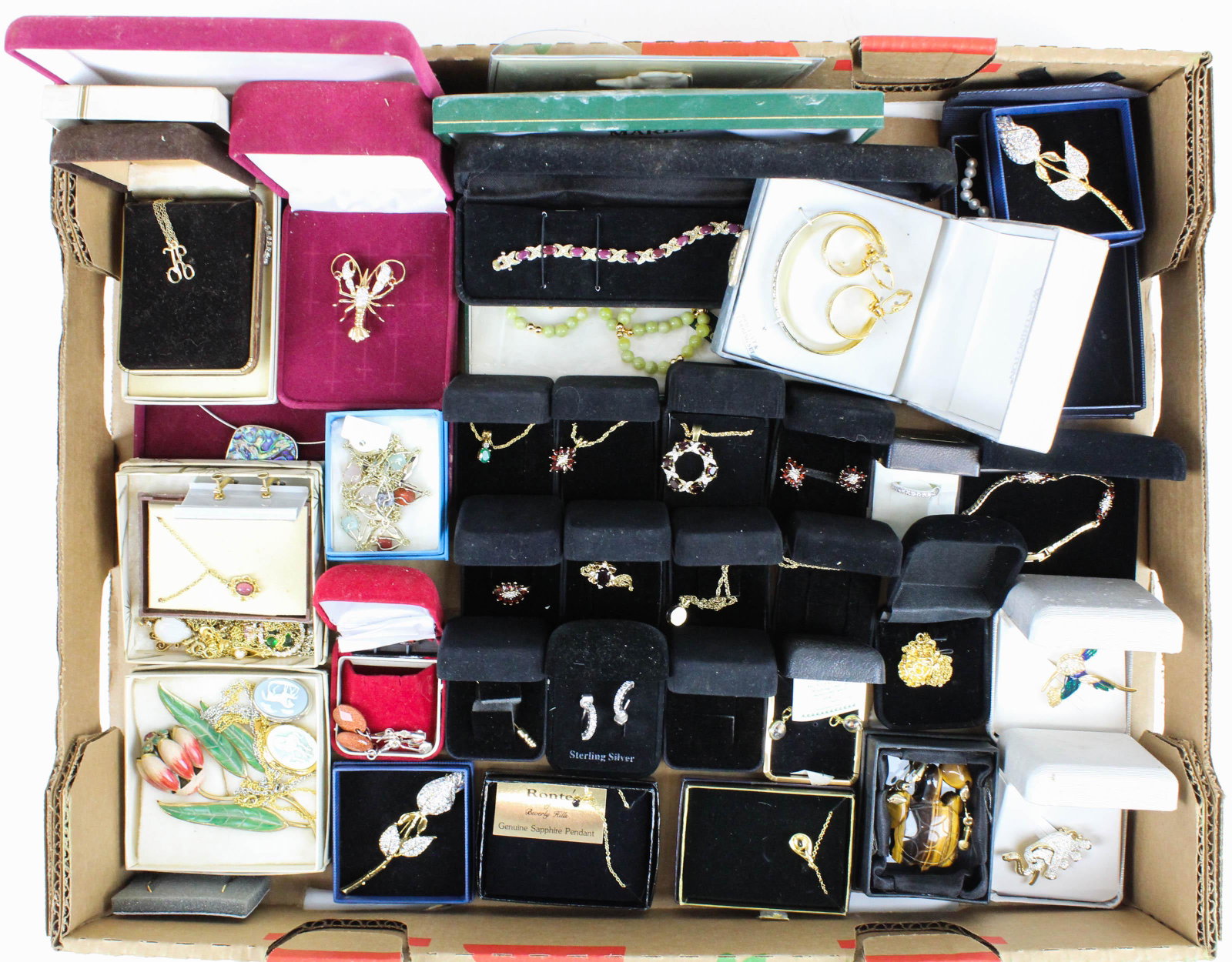 Group of New Old Stock Costume Jewelry: Group of costume jewelry including many new old stock items in original boxes and packaging, unused pieces, garnet pendants, rings, earrings, bracelets, lockets, suite of freshwater pearls, etc.