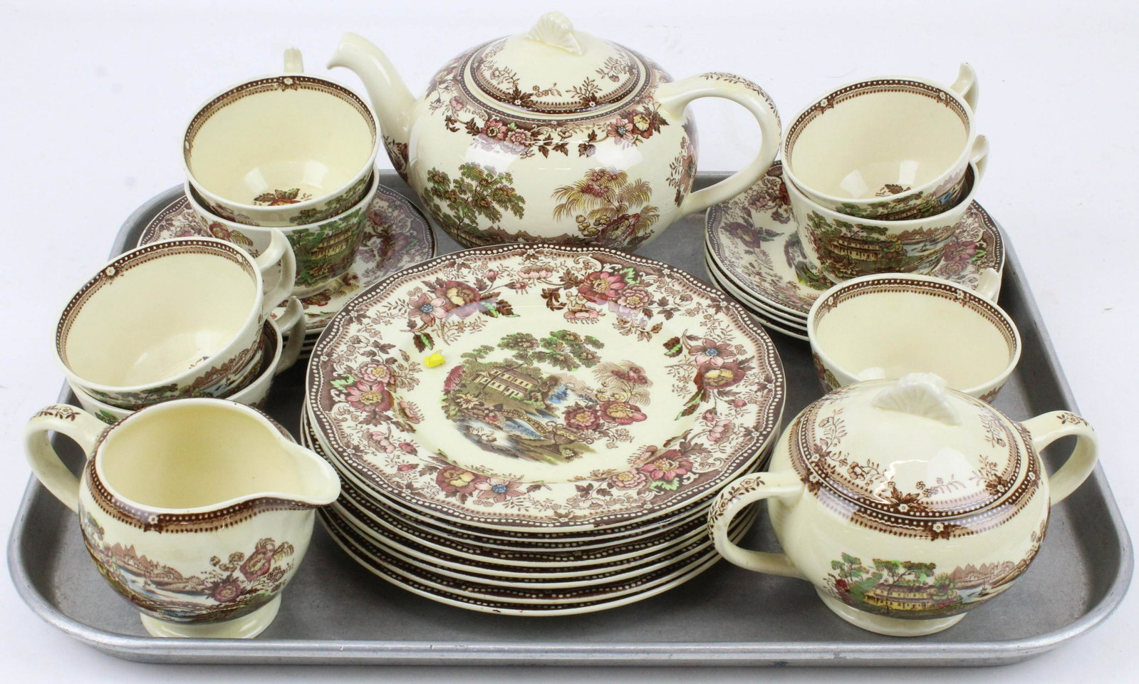 26 pc. Clarice Cliff Tonquin Porcelain Tea Set: 26 pc. Clarice Cliff "Tonquin" pattern English brown and polychrome transfer decorated porcelain tea set, including 7 teacups and saucers, 8 luncheon plates, teapot, sugar and creamer, accompanied by 