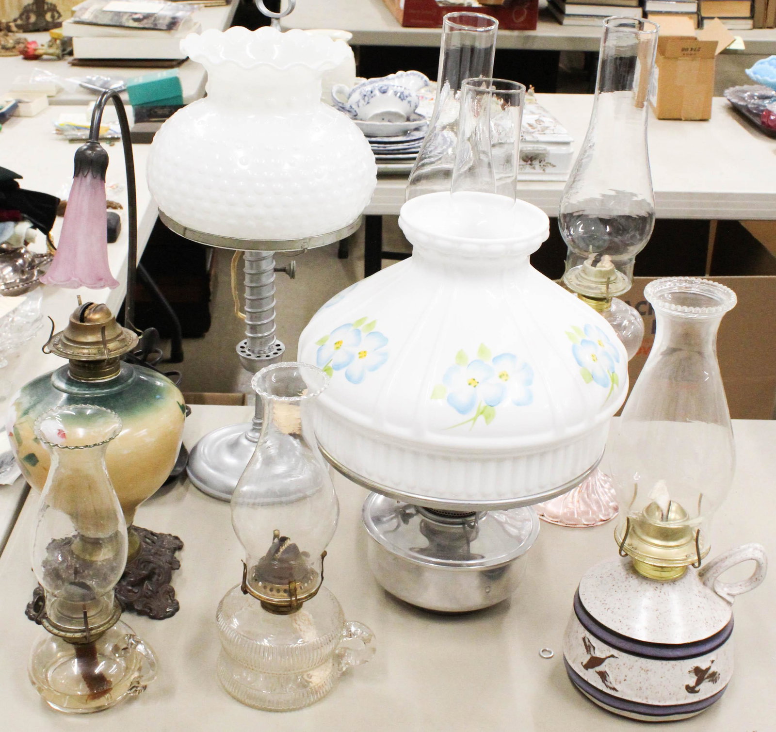 Lot of Vintage Lighting and Oil Lamps: Lot of Vintage Lighting including student lamp with hobnail shade, reproduction Art Nouveau desk lamp, Aladdin lamp with handpainted shade, pair of twisted stem oil lamps, two finger lamps, Onion Rive