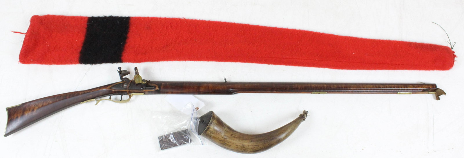 Mid 20th C Hatfield Flintlock Rifle in .45 cal: Mid 20th c 20th century Hatfield flintlock rifle in .45 caliber with flame maple stock with Hudson Bay type scabbard, tin tool kit with screwdriver, worm, and flints. 19th c powder horn 14" long. Rifl