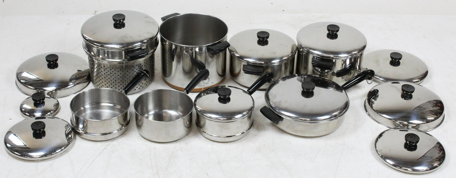 Group of Revereware Stainless Cookware: Group of Revereware American Stainless Cookware including 2 stockpots, pasta pot, 3 part steamer, skillet with dutch oven lid, etc. with numerous extra lids, some items copper clad bottom, some with h