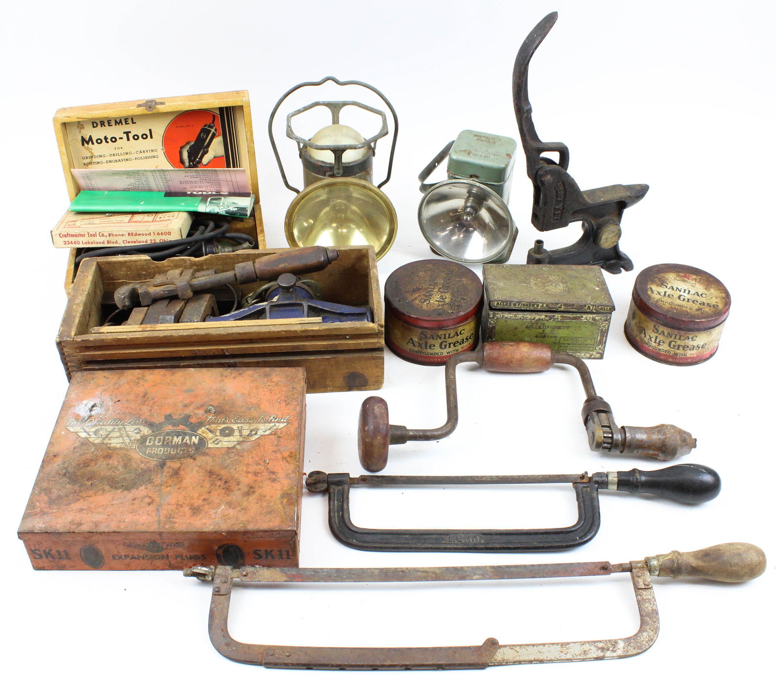 Group of Vintage Hand Tools and Garage Items: Group of Vintage Hand Tools and other garage items including Socony Axle Grease tins, lanterns, tap and die set, hacksaws, folding rules, early Dremel tool in wood case, level, padlock, etc.