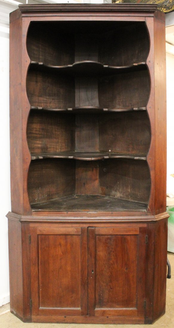 18th c Chippendale Corner Cupboard: 18th c Chippendale two part cherry corner cupboard. Upper section with cornice molding and lolly pop shelves. Lower section with single door. 40" wide x 80" h.
