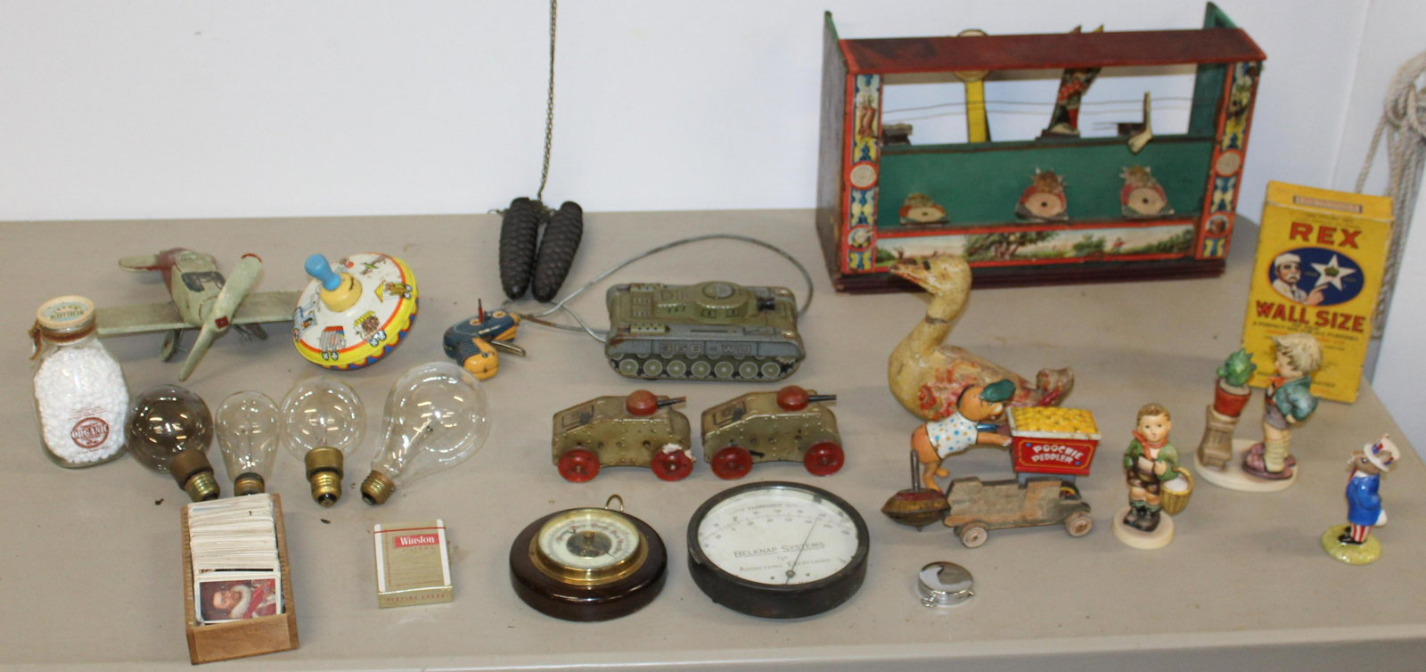 Lot of Toys Lot of Toys including Tin Litho: Lot of toys including tin litho Tank, Composite Goose Homemade airplane, Lithograph Shooting Gallery As found, Hummels etc. Early Light bulbs and New Old Stock Wall Size.