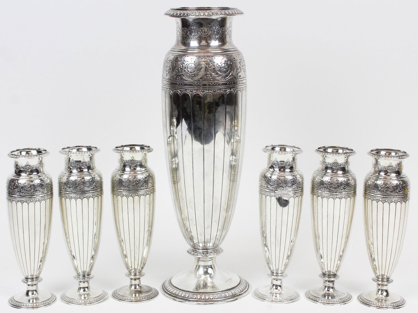 Tiffany and Co. Sterling Silver 7 pc. Vase set: Fine ca. 1920 Tiffany & Co. sterling silver 7 piece table garniture set consisting of large bouquet vase and 6 individual place setting vases, having neoclassical cast rim, Italian renaissance style f