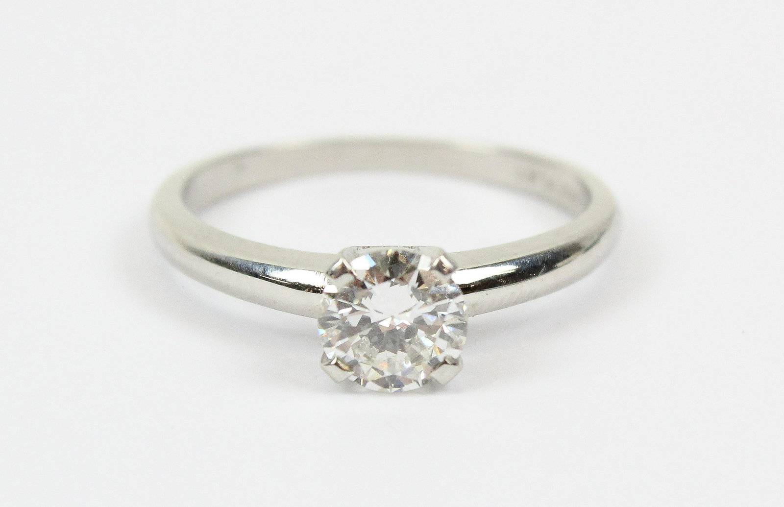 Platinum & Diamond Engagement Ring: Platinum and diamond engagement ring having a round cut solitaire diamond measuring 5.5 mm x 4 mm or 2/3 ct, VS1, G/H. Ring size 7.