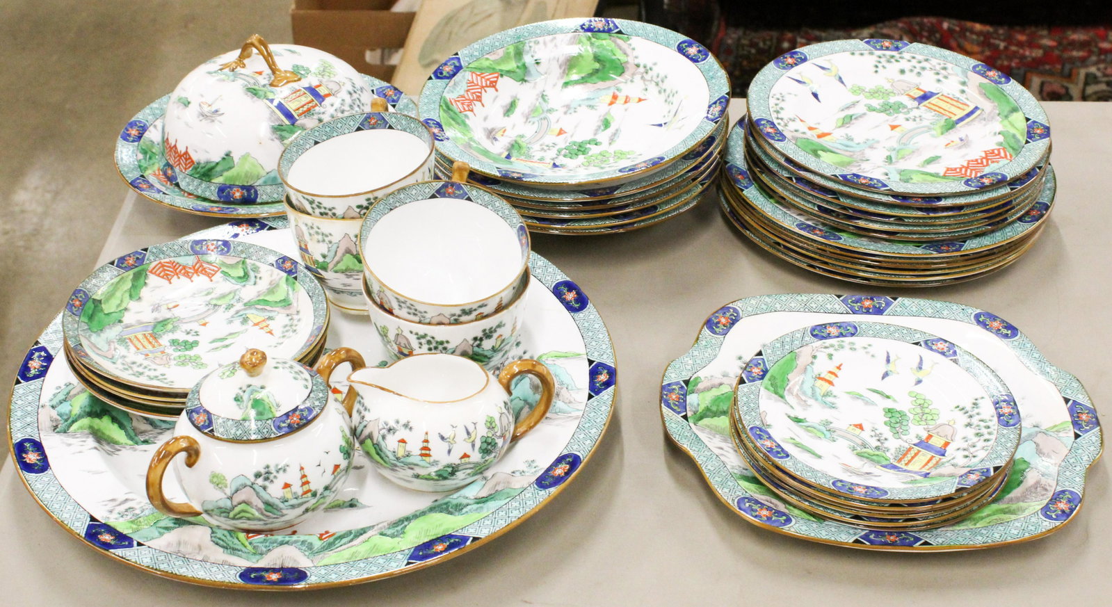 33 pcs. Crown Staffordshire Porcelain Tableware: 33 pcs. Crown Staffordshire porcelain tableware retailed by Tiffany & Co. New York, having fine polychrome applied enamel Orientalist scenes to include 6 soup bowls, 6 luncheon plates, 6 dessert plate