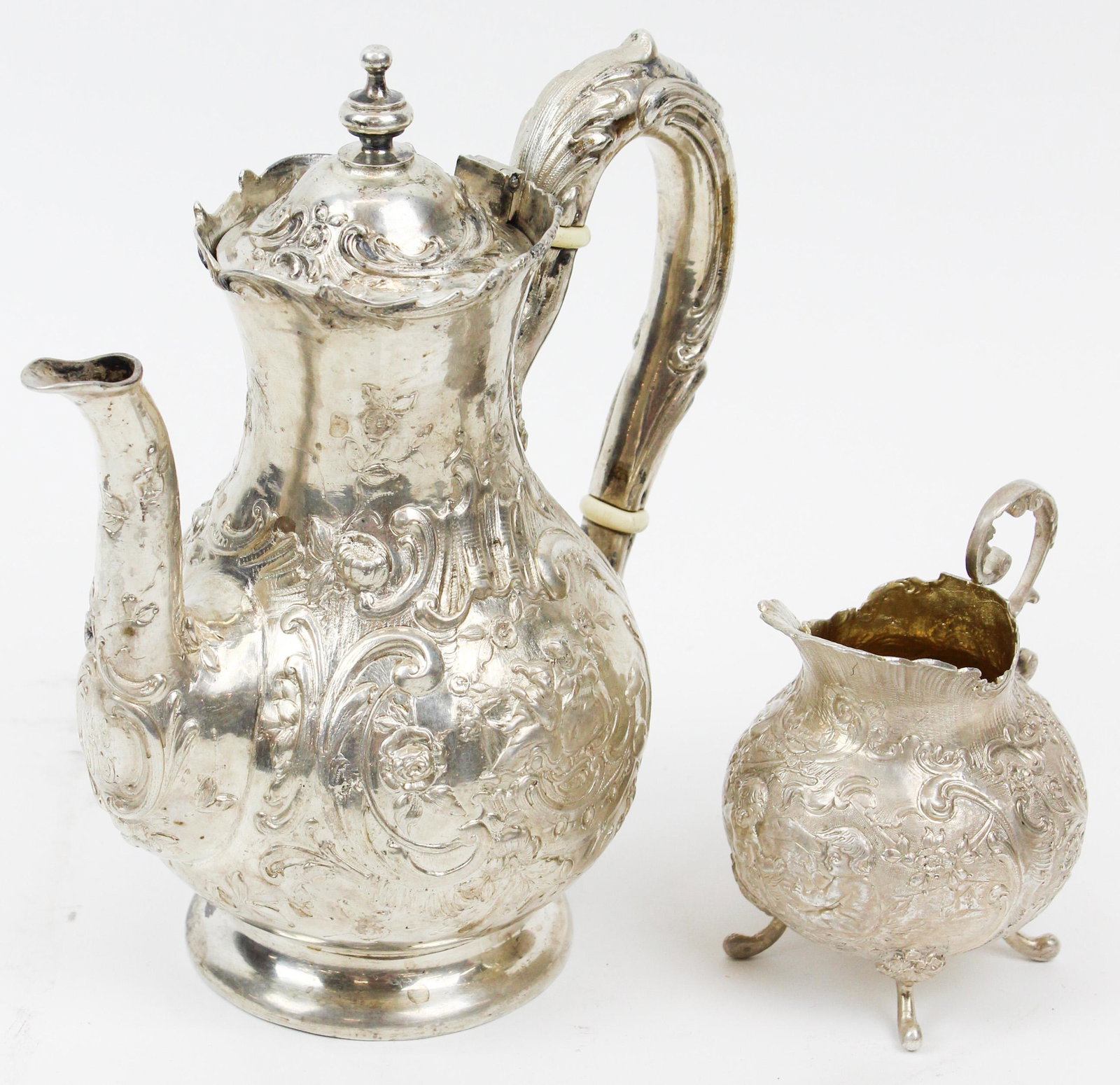 Continental 800 Silver Coffee Pot and Creamer: Continental 800 silver coffee pot and creamer with profuse all-over rococo style repousse decoration surrounding romantic scene cartouches with figures, teapot having obscured inscription "World's Fai