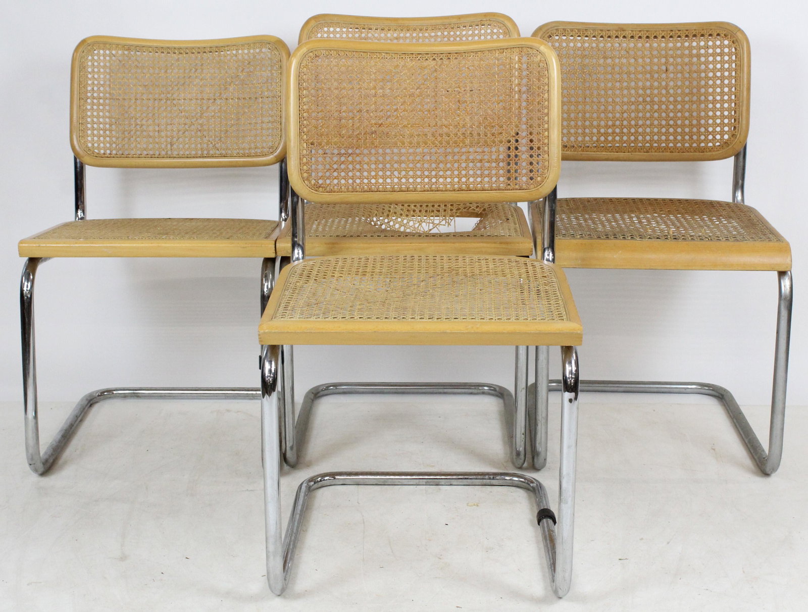 11 Marcel Breuer-type Cesca Chairs: A set of 11 Marcel Breuer type Cesca cane seat and back chairs. Chrome bent metal design. Damage to cane on some chairs. Marked made in Italy