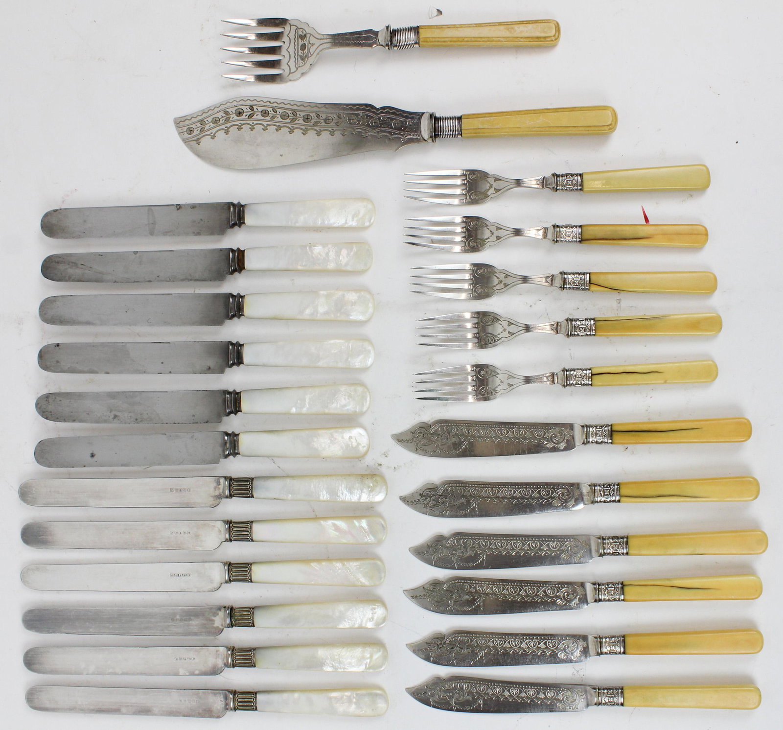 Victorian Fish Cutlery Set and MOP Handle Knives: Victorian English Sheffield plate fish serving cutlery set consisting of large fork and knife, place setting forks and knives having elaborate bright cut blades and vegetable ivory handles, accompanie