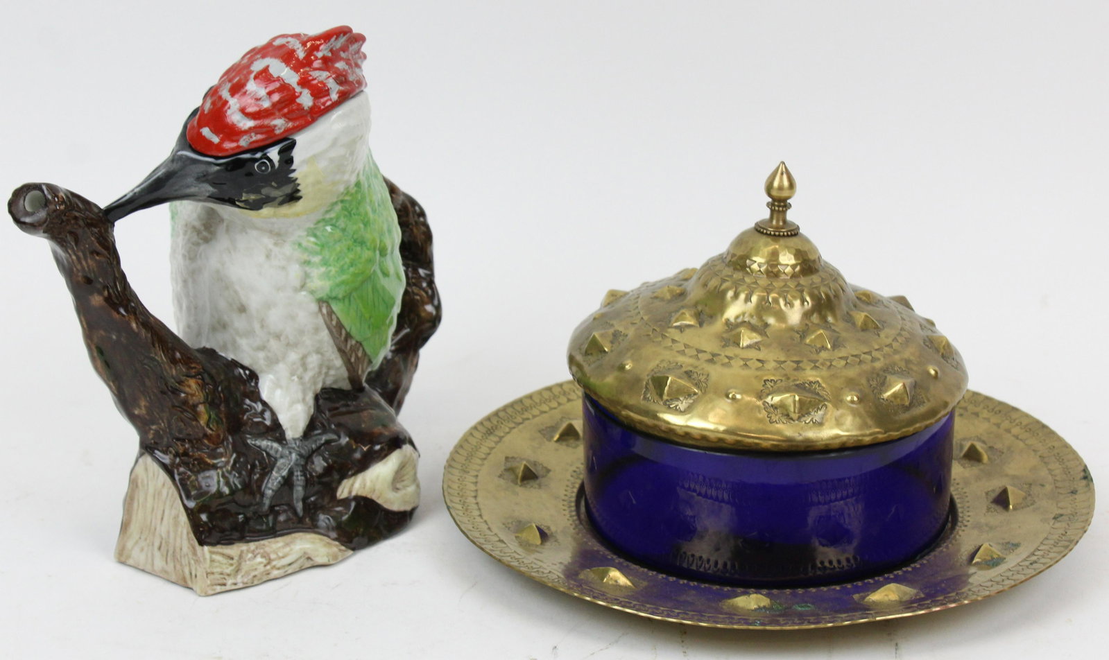 Handwrought Brass Caviar Dish, Porcelain Teapot: early 20th c. German cobalt glass caviar dish having handwrought medieval style brass lid and undertray, signed "Handarbeit", accompanied by a Staffordshire Fine Ceramics figural woodpecker tea pot. 6