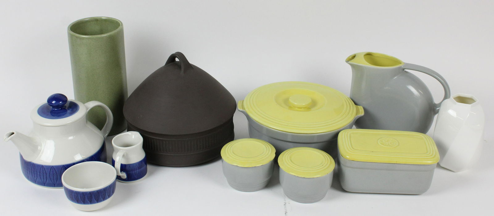 Lot of Vintage Kitchen Pottery incl. Dansk, Haeger: Lot of Vintage Kitchen Pottery including Dansk flamestone covered casserole dish, 3 pc. Rorstrand Swedish cobalt banded tea set, 5 pcs. 1950's G.E. Hall Pottery gray and yellow Art Deco refrigerator w
