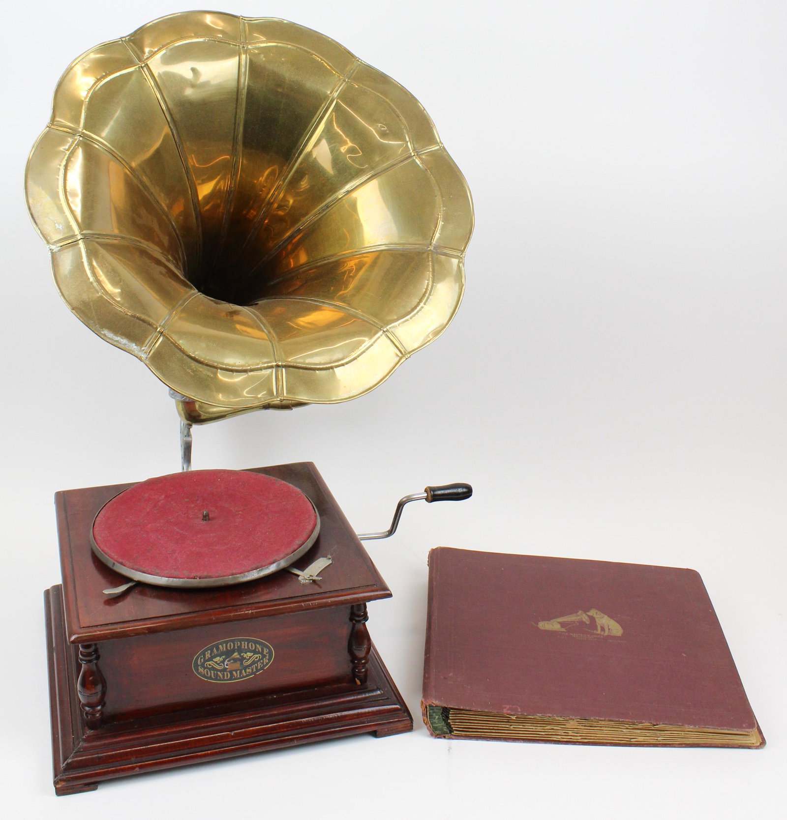 Replica Gramophone With Brass Horn: Late 20th c. replica disc gramophone crank wound record player with brass horn, accompanied by album of 78 rpm records. 29" x 16" x 19"