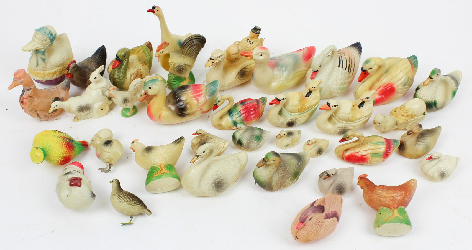 Early Celluloid Toys and Figures: Early 20th celluloid swans, chickens, ducks, including rattles (34 pcs), 2" to 9 1/2"