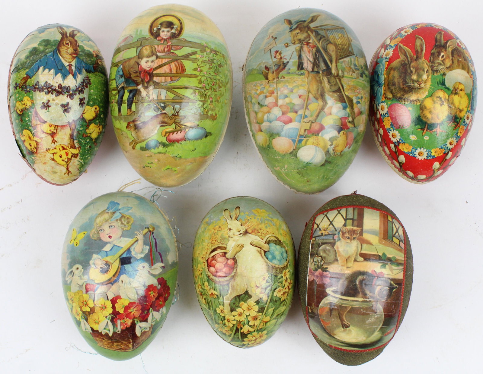 7 Large Easter Egg Candy Containers: 7 large Easter Egg Candy Containers, color litho with Dresden trim, paper mache and boxboard, lengths 6" to 8", some with trim losses