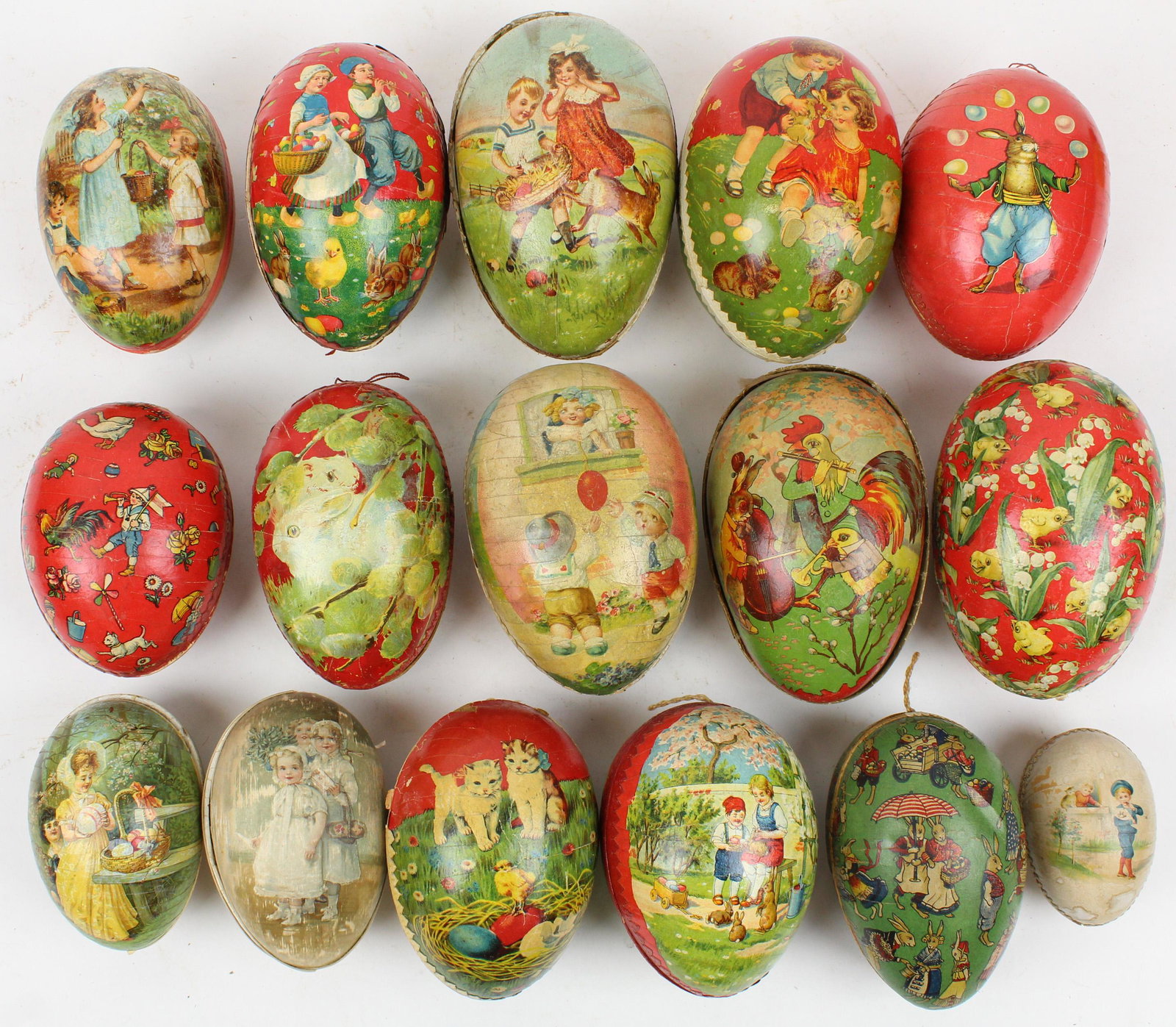 13 Easter Egg Candy Containers: 13 medium to large Easter Egg Candy Containers, color litho with Dresden trim, paper mache and boxboard, sizes 3" to 7 1/2", sold with a silk egg and 2 egg halves