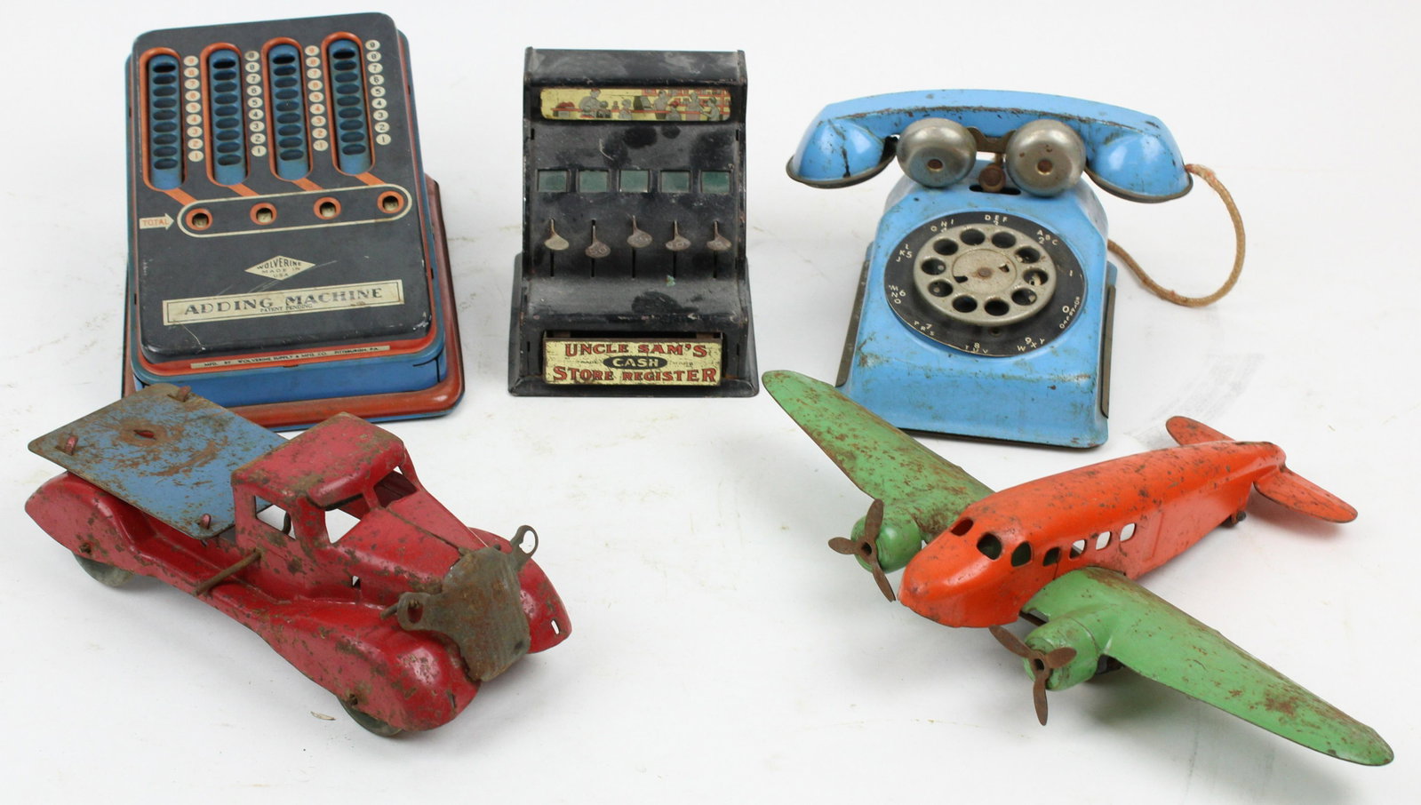 Pressed Steel Toys, Tinplate Bank: Pressed steel rotary phone, Wyandotte airplane (missing tail rudder), and truck, tinplate adding machine, Uncle Sam bank, lengths to 9"