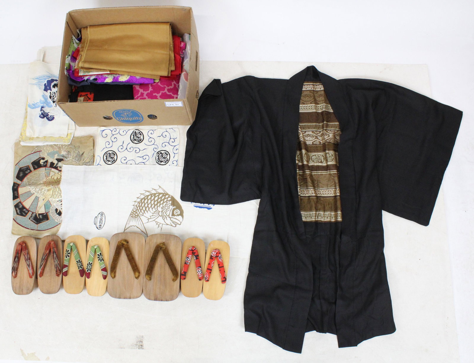 Lot of Japanese Silk Garments and Fragments: Lot of silk garments and fragments brought back from Japan during World War II by Col. Robert Thayer of Burlington, VT, including metallic dragon embroidered pillow cover, black men's robe, printed ar