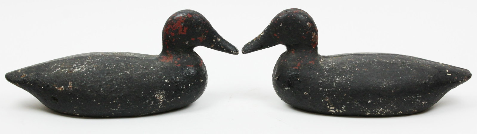Pair of Early 20th c Cast Iron Duck Doorstops: Pair of early 20th c cast iron duck doorstops, black paint over red & white and black paint, solid cast iron, lengths 15 1/2" (due to weight, shipping costs should be considered, local pick-up/ privat