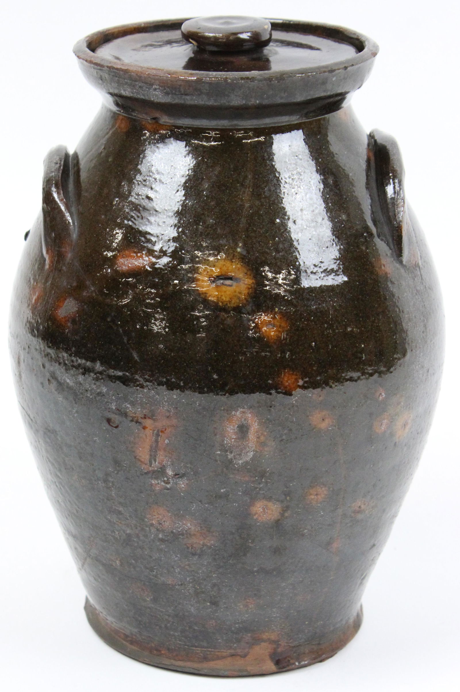 Early 19th c Redware Ovoid Jar with Lid: Early 19th c redware ovoid jar with lid, speckled orange splotches on brown manganese ground, ht 9 1/2", cracked on one side, sold to benefit the Vermont Historical Society