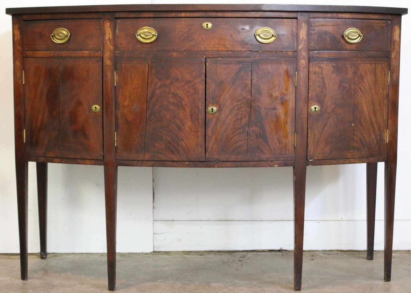 Mid Atlantic Federal Inlaid Sideboard: Maryland or Mid Atlantic Federal bow front sideboard. Cherry top, mahogany veneer, 3 drawers over 4 doors. Fine string, leaf & vine inlay. Long southern pine secondary, cherry top. 60" wide. 41" h, 23