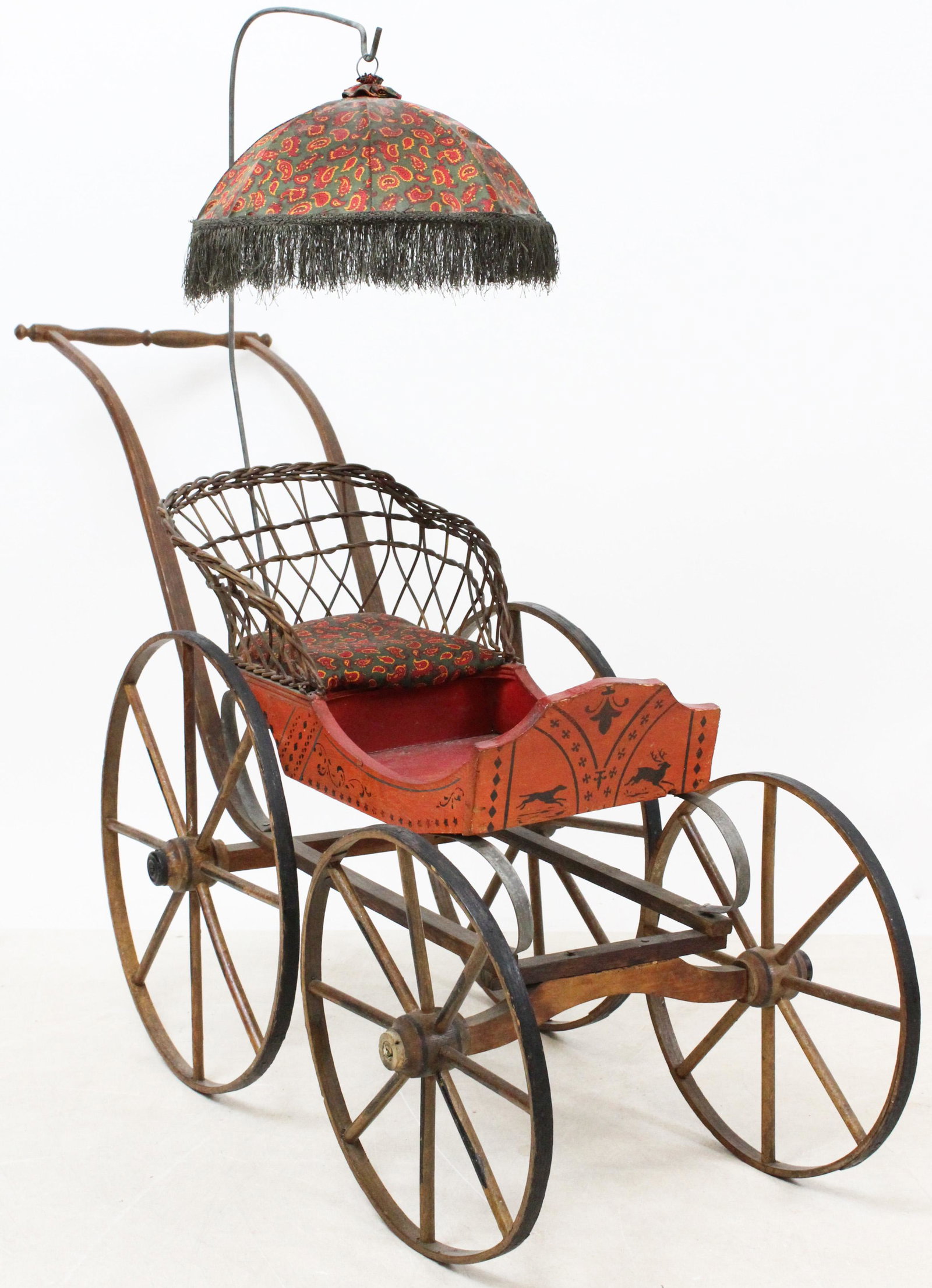 Joel Ellis Springfield Vermont Doll Carriage: A fine Joel Ellis Springfield VT doll carriage. Excellent original condition. Original red paint with green & black stencil. Wicker type seat. 40" long, 26" h to handle.