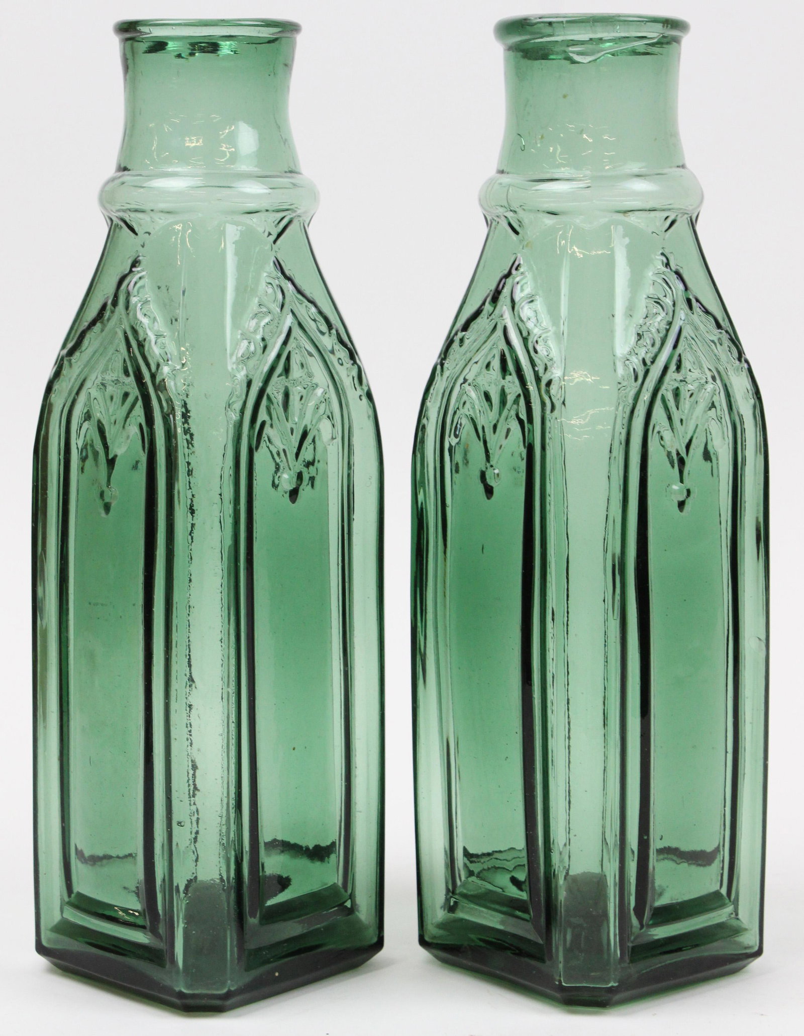 Pair of 19th c Cathedral Pickle Bottles: Pair of 19th c Cathedral pickle bottles in light emerald green glass, graphite pontils, hts 11 7/8", sold to benefit the Vermont Historical Society