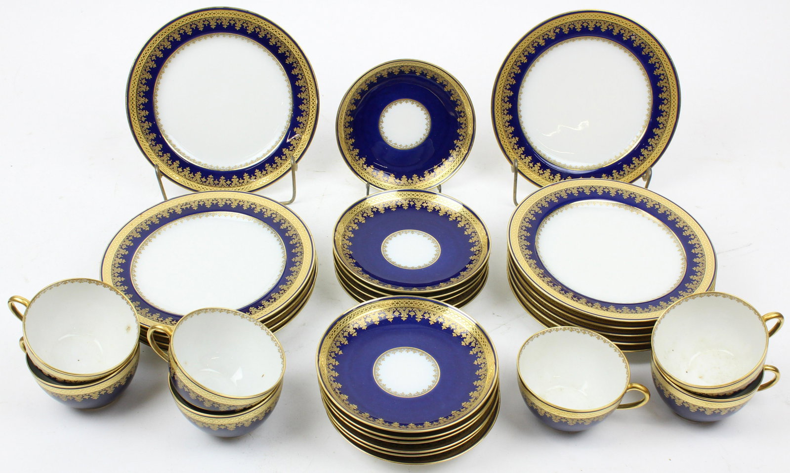 29 pcs Haviland Limoges Cobalt and Gilt Porcelain: Group of 29 pcs. Haviland Limoges Cobalt banded and gilt engraved rim porcelain tableware including 10 luncheon plates, 12 saucers, and 7 cups dia. 7.75"