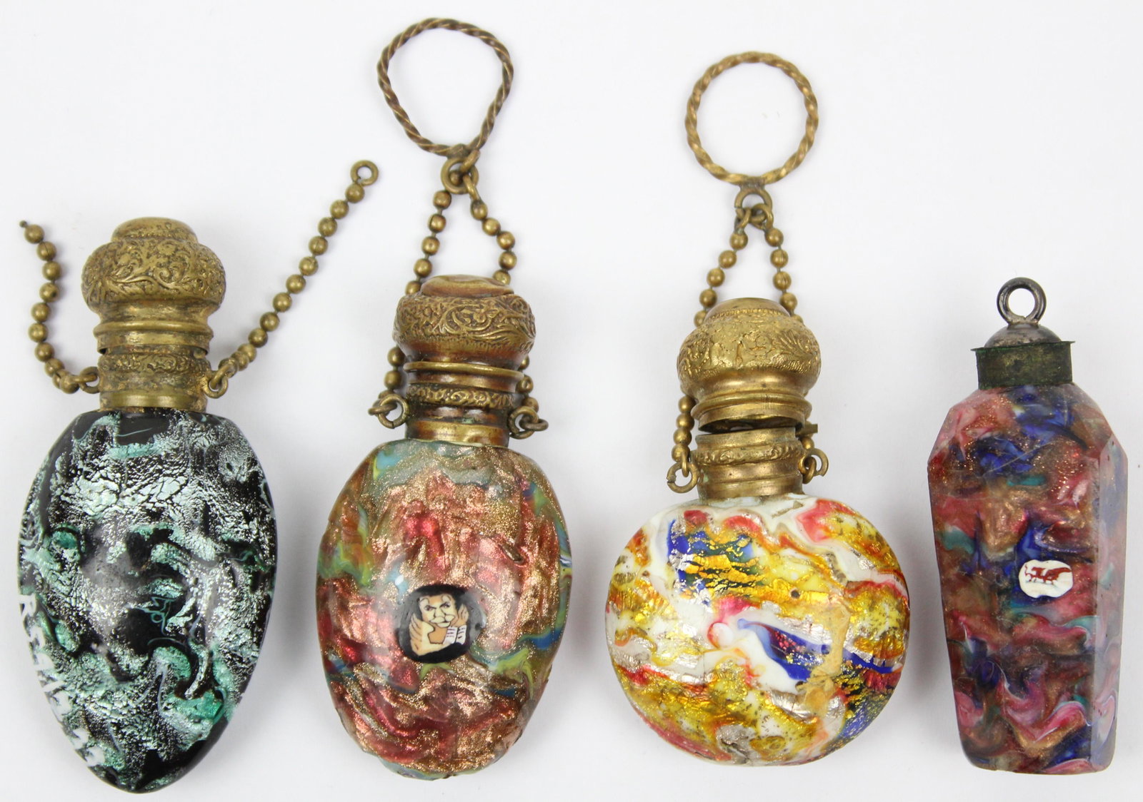 4 Aventurine Venetian Glass Perfume Bottles: Group of 4 late 19th c. Aventurine Venetian art glass perfume bottles in various mottled colors with goldstone streaks, two having chatelaine chains ht 2.5"-2.75" -one with flakes to base, imperfectio
