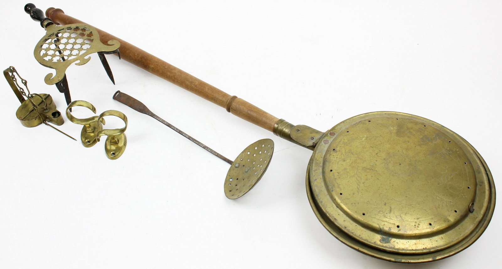 19th c Brass Betty lamp, Jam Hooks, Trivet: 19th c brass betty lamp, jam hooks, trivet, bedwarmer, sieve spoon, lengths from 3 1/4" to 44 1/2", sold to benefit the Vermont Historical Society