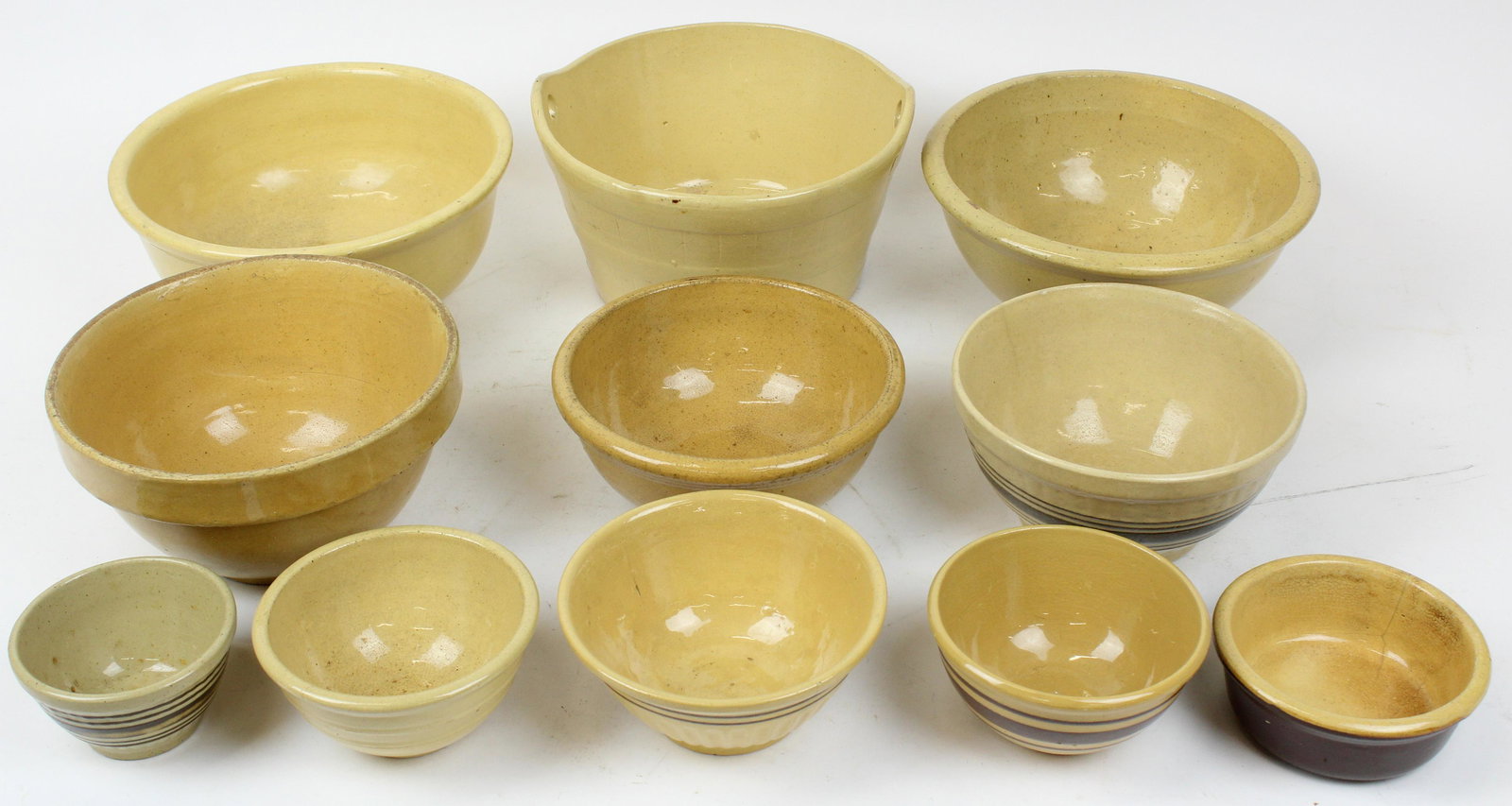 Group of 11 Various Yelloware Bowls: Group of 11 various yelloware bowls including banded, brown glazed, etc. -some with imperfections dia. 5"-9.25"