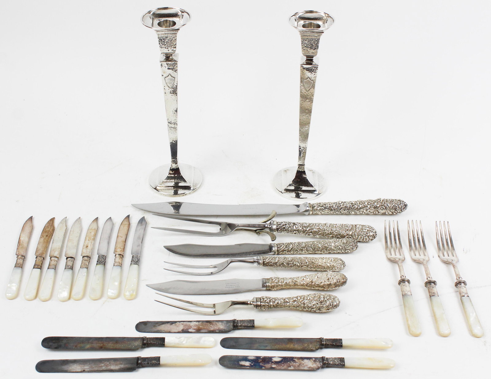 Group of Kirk and Steiff Sterling Carving Sets: 3 sterling silver handled carving sets including 2 S. Kirk & Sons "Repousse" pattern sets, and a Stieff "Rose" pattern set, accompanied by a pair of weighted tapered tall candlesticks with hand-hammer
