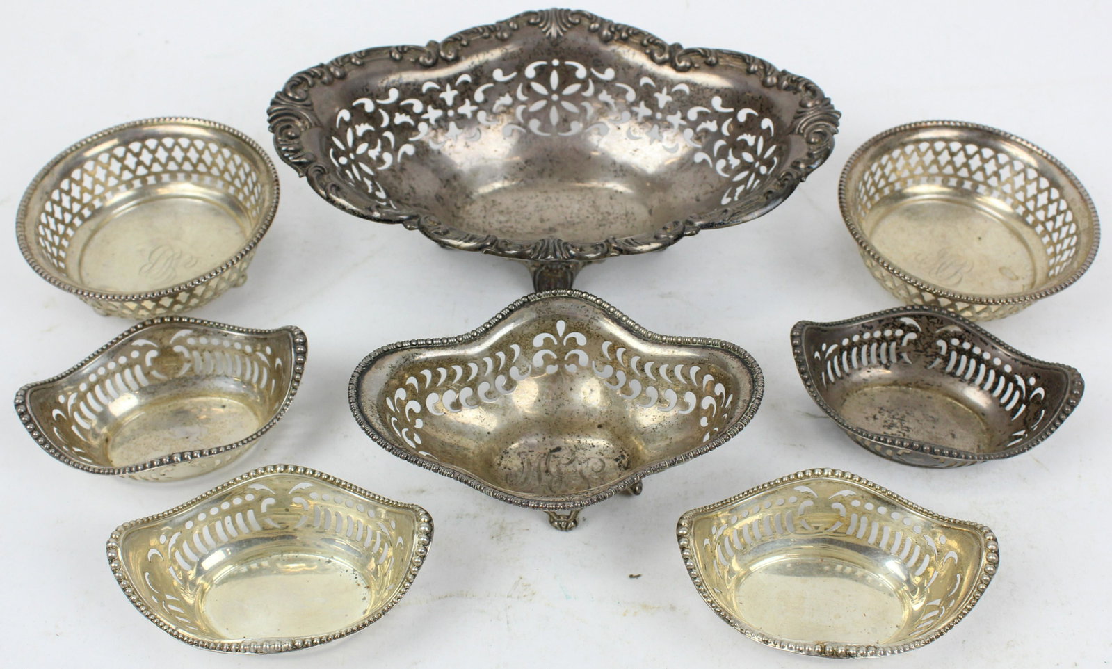 8 Edwardian Reticulated Sterling Bon Bon Dishes: Group of 8 Gorham late Victorian or Edwardian era reticulated sterling silver bon bon or nut dishes, including larger footed dish, set of 4 Gorham individual dishes with beaded edge ht. 1"-2.25" 9.3 t