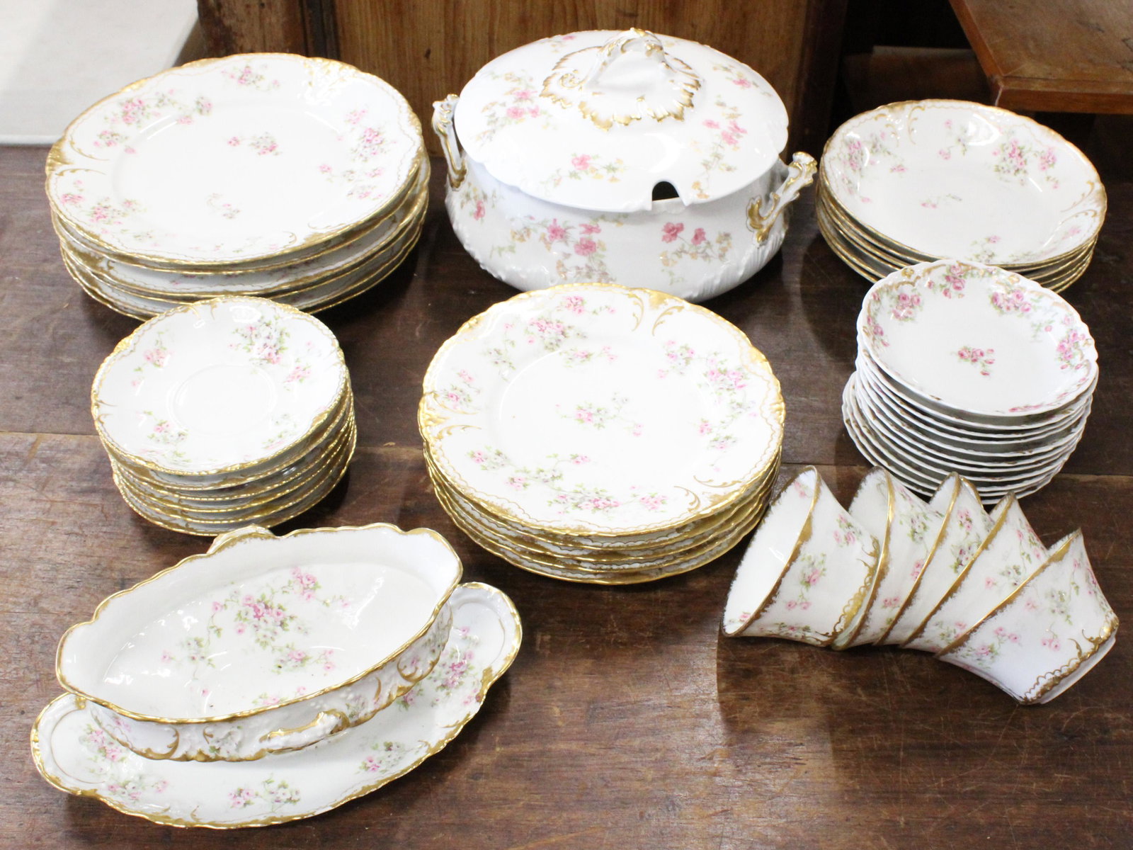 41 pcs. Limoges Pink Floral Porcelain Dinnerware: Group of 41 pcs. Limoges Pink Floral decorated porcelain dinnerware including a number of Theodore Haviland "67L" pattern, a covered tureen dish, and other side dishes