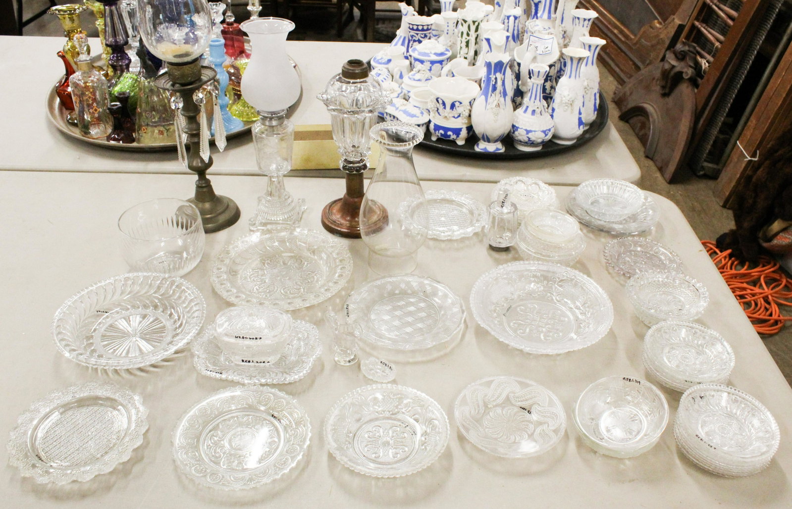 Early Lighting and Sandwich Pattern Glass: Large lot of lighting and EAPG Early American Pattern Glass including paneled peg lamp font, wheel etched whale oil fluid lamp with frosted shade, brass candlestick with blown hurricane shade, Sandwic