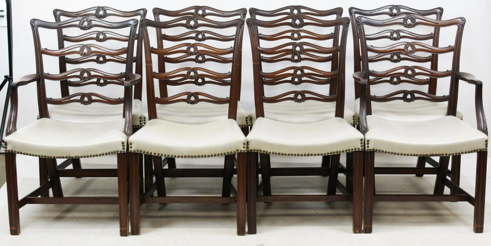 Set of 8 Fine Mahogany Chippendale Chairs: Set of 8 Fine Mahogany Custom Chippendale Ribbon Back Dining chairs with foliate carving and moulded leg, six side chairs and two arm chairs Back 37" Seat 18" H 18"d 21"w nicely recovered in leatheret
