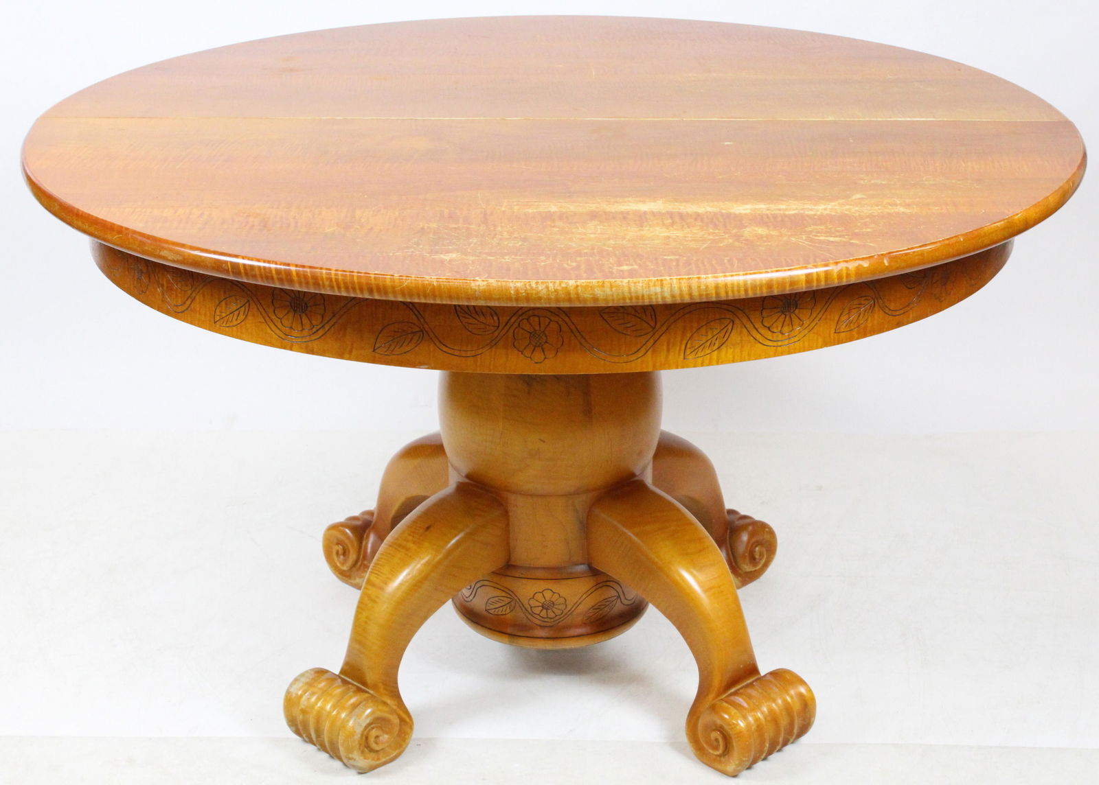 Stephen Huneck Tiger Maple Sunflower Table: Made for Stephen Huneck tiger maple round pedestal dining room extension table. Rolled claw type foot, round pedestal, & round tiger maple top. Carved top skirt edge and pedestal base edge with vine,