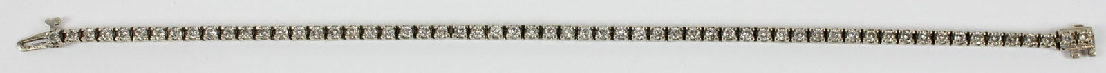 Diamond & White Gold Tennis Bracelet: 14k white gold and diamond tennis bracelet with 49 .04 ct diamonds each individually hinged set. 7 1/4" long. Approx. 2 cts total weight.