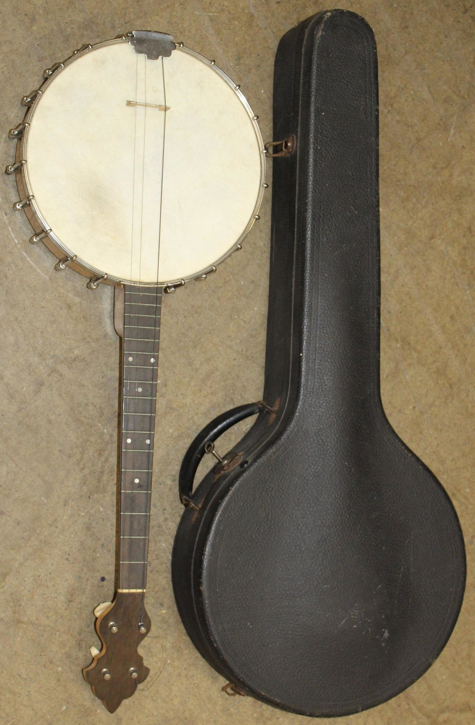 Weymann Tenor Banjo: Weymann Tenor Banjo circa 1920 with original hard shell case with green corduroy interior, overall nice shape with decal on headstock 11" head, 30" overall length appears in good playable condition.