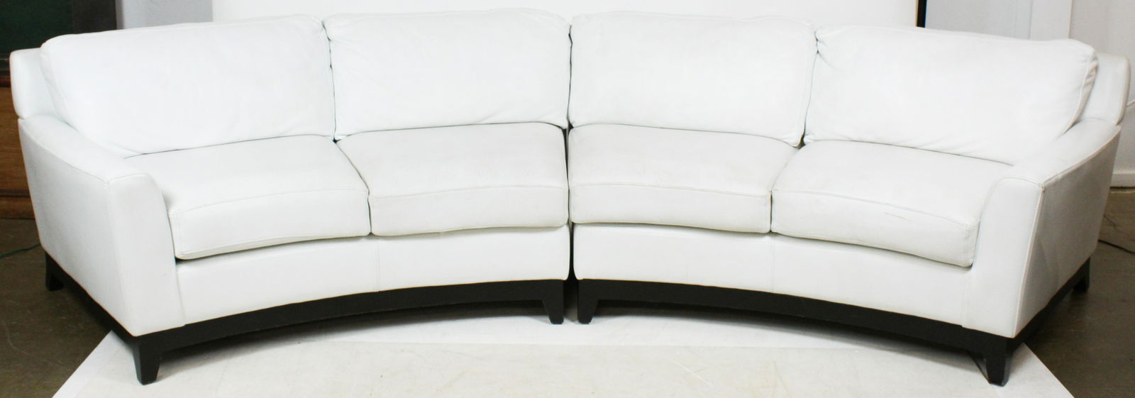Elite Curved White Leather Sofa: Modern white leather sofa, two curved sections, by Elite -Chino CA. 148" long, 36" deep, 31" high to back.