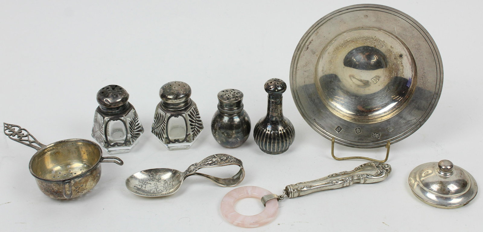 Group of Assorted Sterling Hollowware: Group of Assorted Sterling Hollowware including small Richard Comyns London dish (4.5" dia), tea strainer, lid, 2 single shakers, "Hey Diddle Diddle" figural baby spoon, child's teething ring, and pai