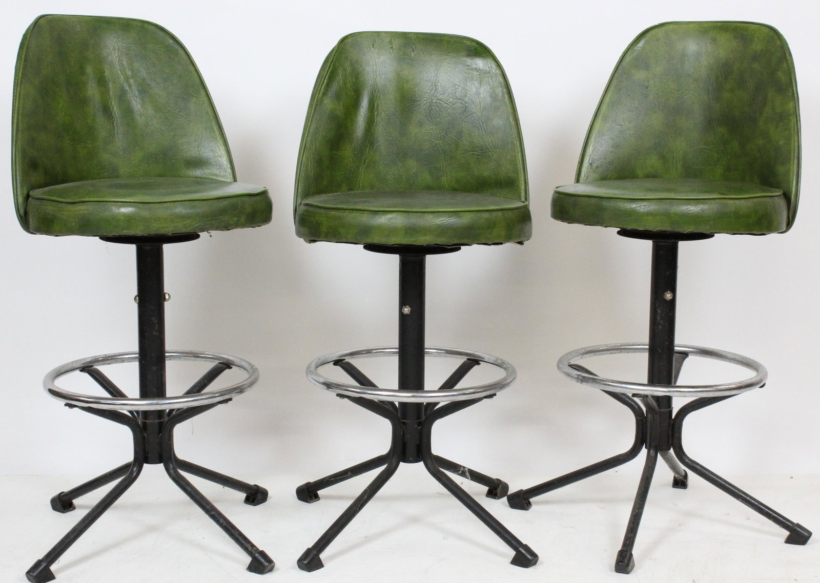 Three mid 1960's green covered barstools: Three mid 1960's green covered barstools 15" diameter 24" to seat